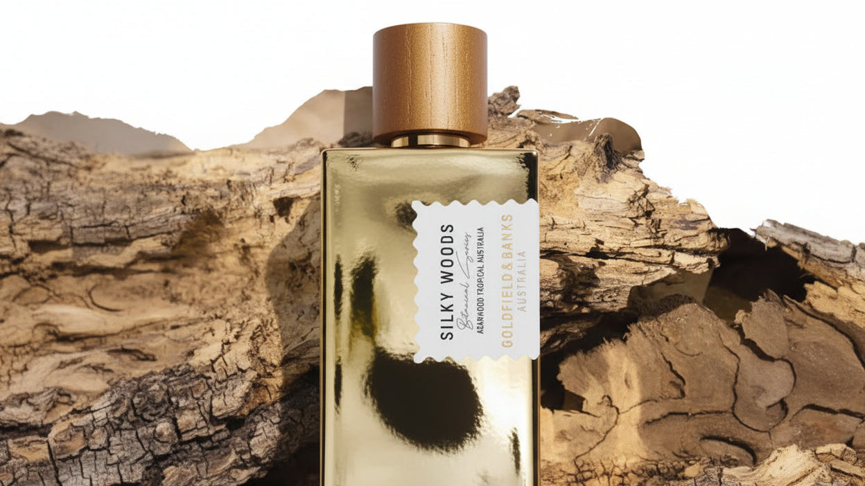 Perfume bottle with gold cap and label on a wooden surface